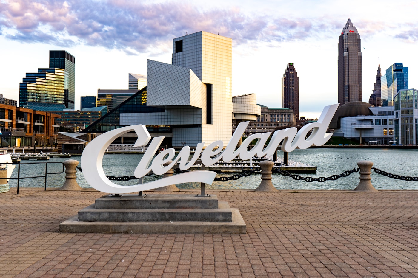 The Cleveland sign on the waterfront with the city skyline behind it