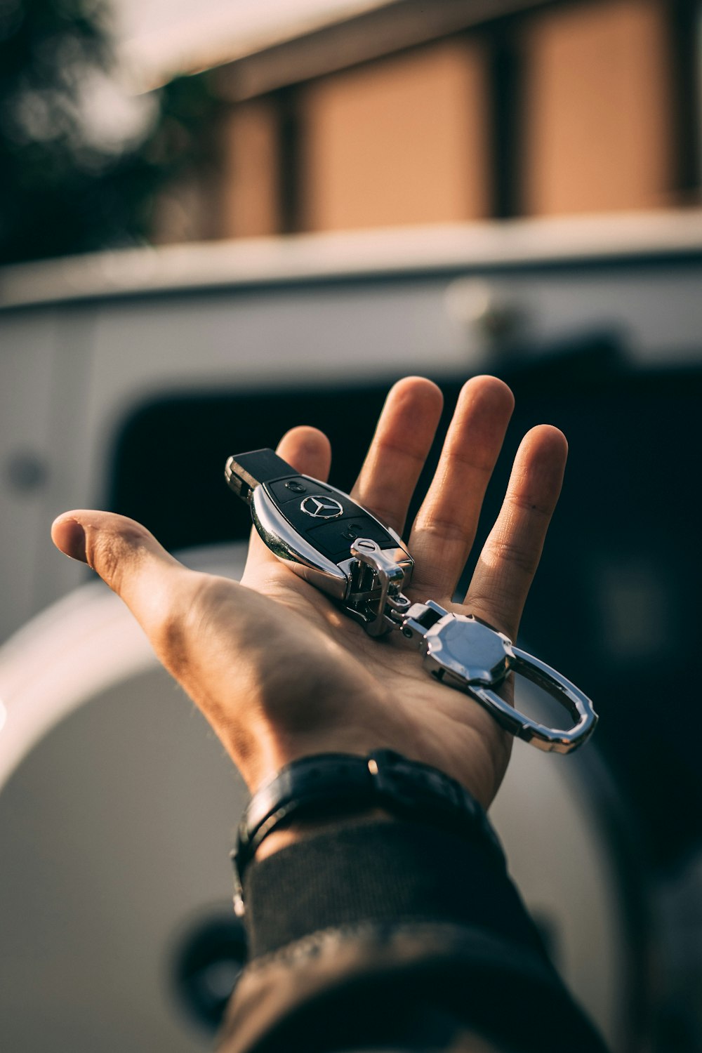 A car key held out in an open hand