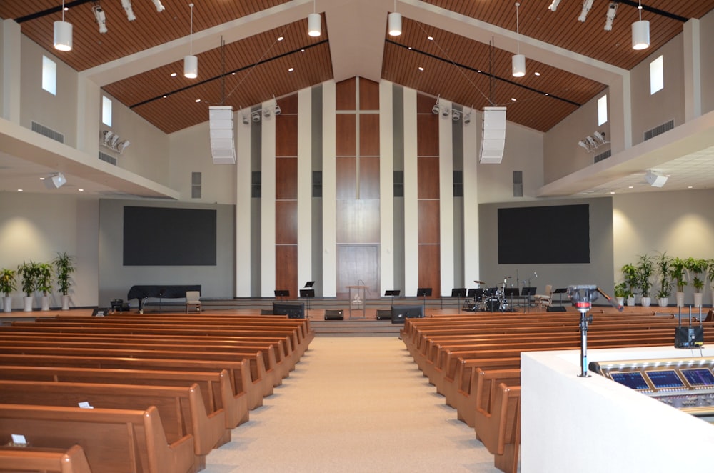 Rows of empty pews facing a church platform