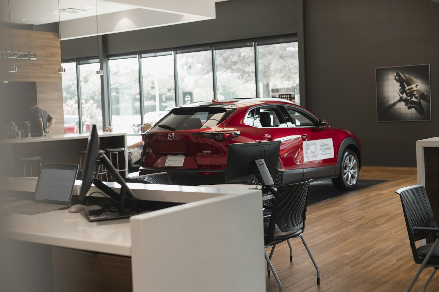 Cars lined up on an indoor dealership showroom floor